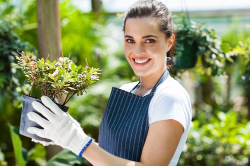 Photograph showing a gardener inspecting a planted bed