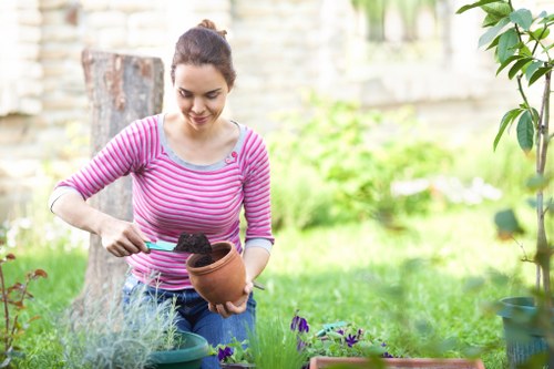 Operative wearing PPE while using a strimmer in a garden